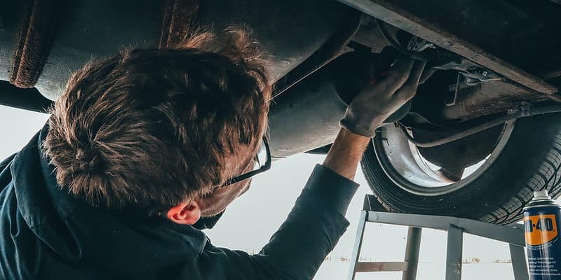 Man under a car changing the oil