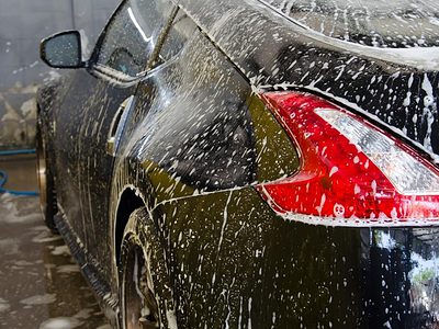 Black car covered in foam