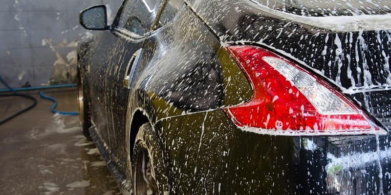 Black car covered in foam