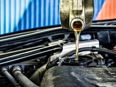 Pouring oil into a car engine