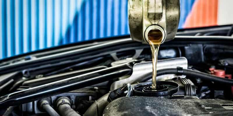 Pouring oil into a car engine