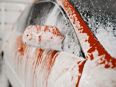 Red car covered in soap