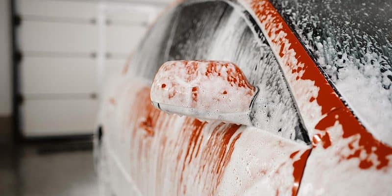 Red car covered in soap