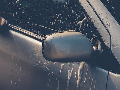 Washing the front side window of a car